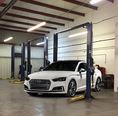 White Audi car in a repair shop
